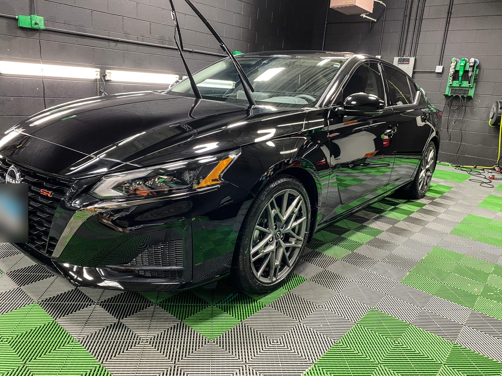 Black sedan with a deep gloss finish after paint work at Unicorn Details McHenry