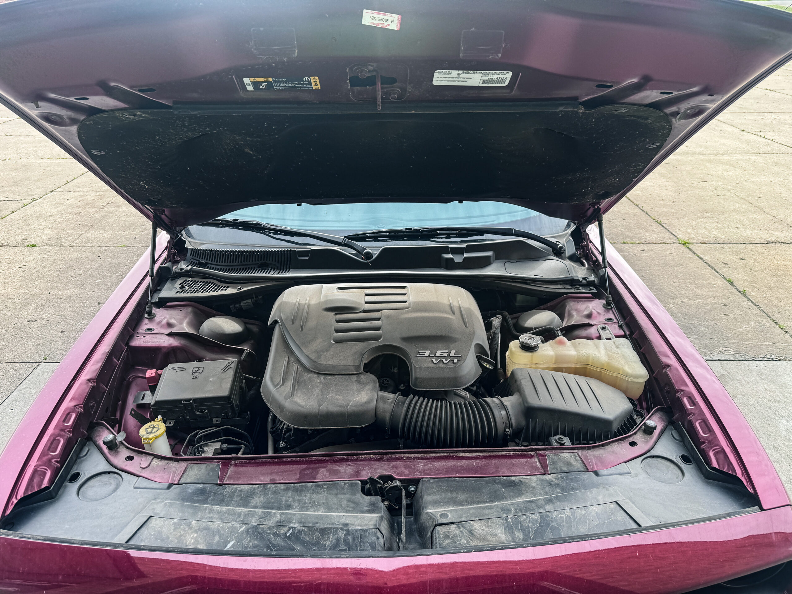 Dusty, dirty engine bay before engine bay cleaning in McHenry, IL by Unicorn Details