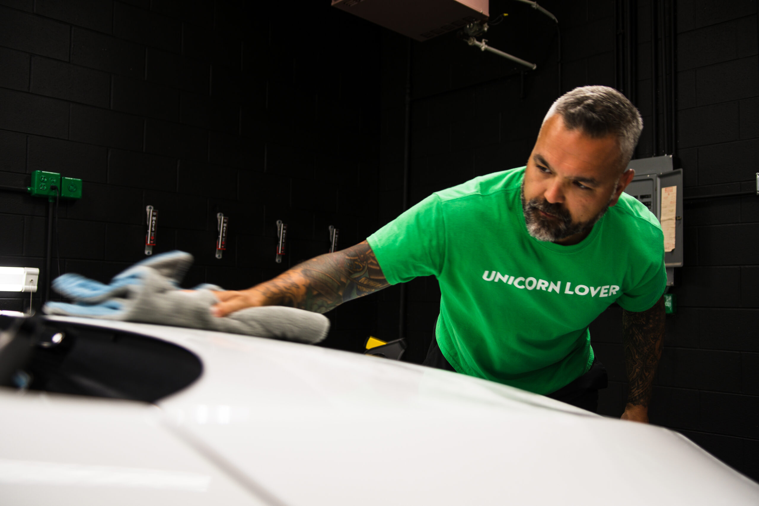 Unicorn Details technician hand drying a vehicle after a coating-safe hand wash